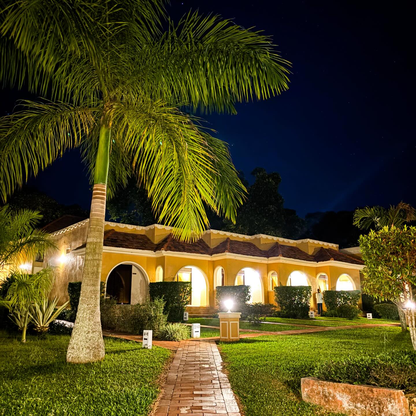 Guest room block and gardens lit at night