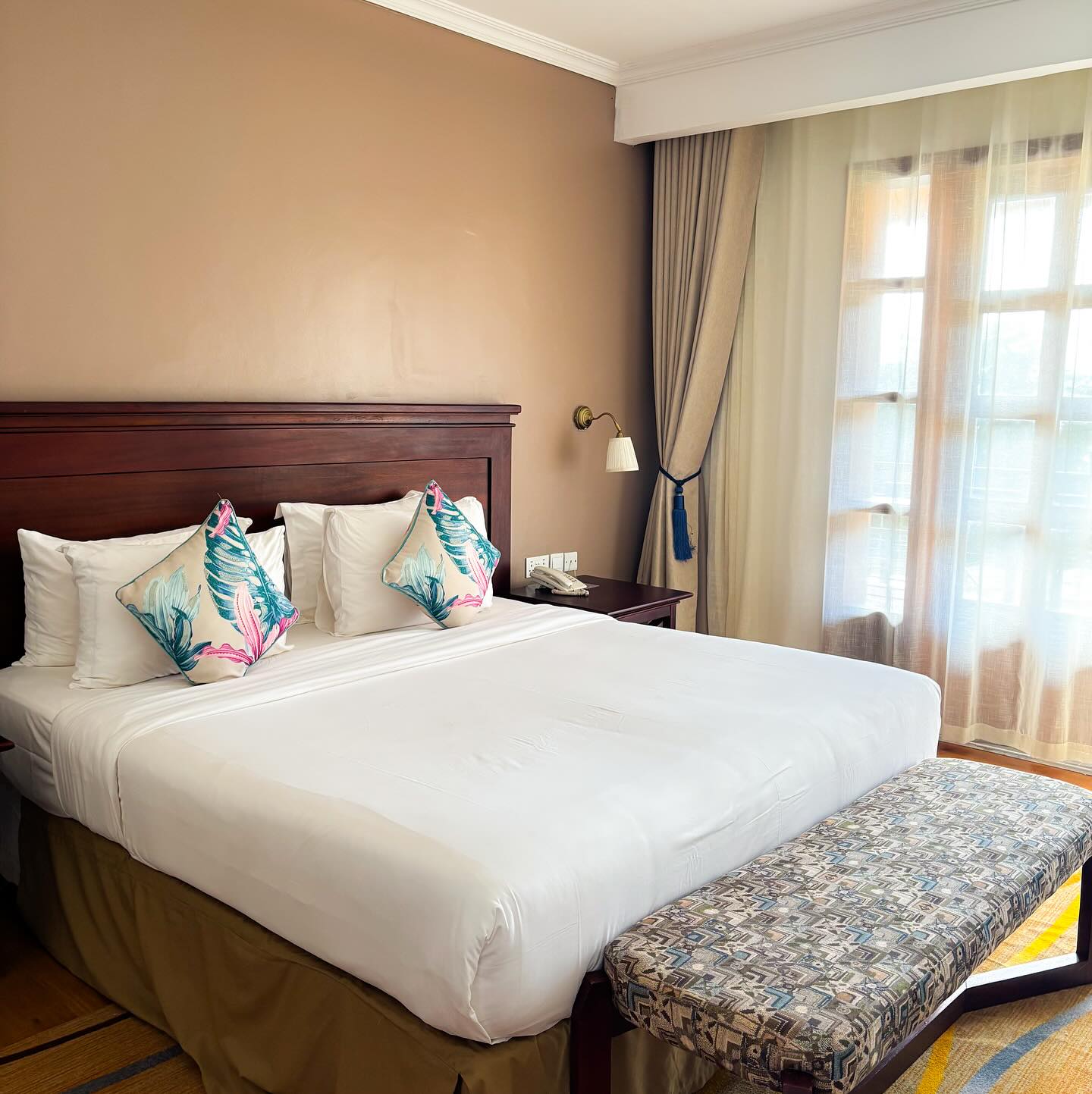 Standard room with a king bed and tropical cushions